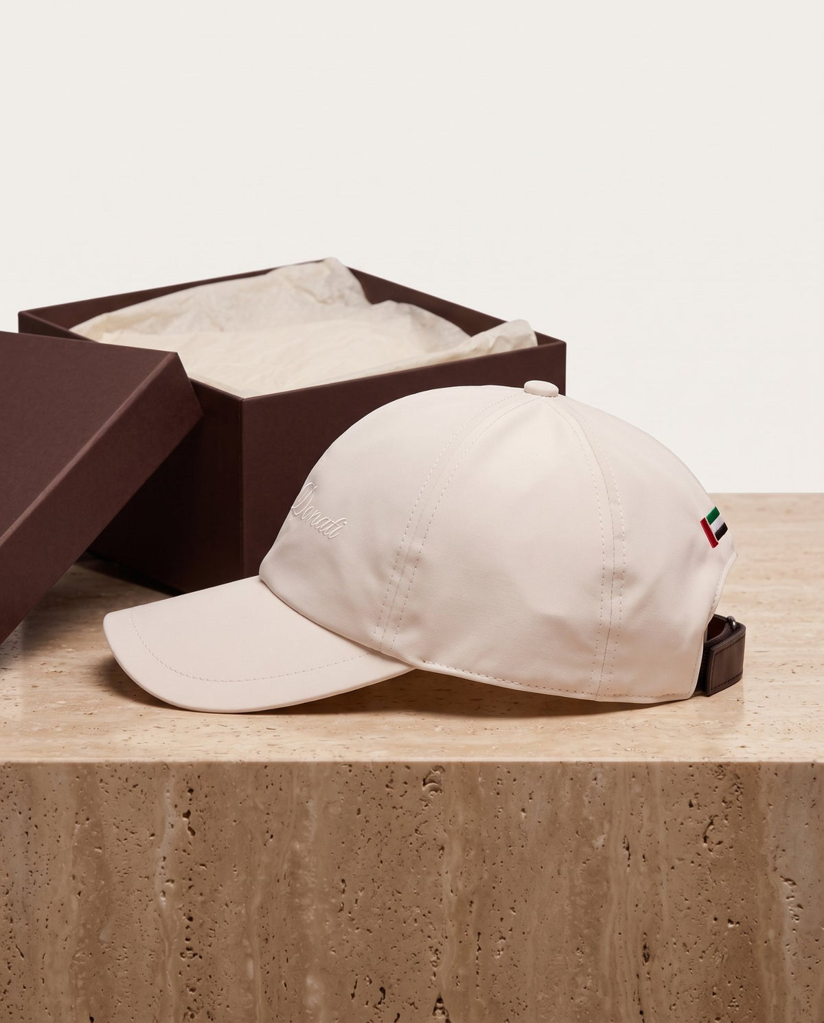The cap with its presentation box